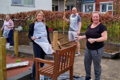 Volunteers from HSBC restoring garden furniture at Rotherham Hospice