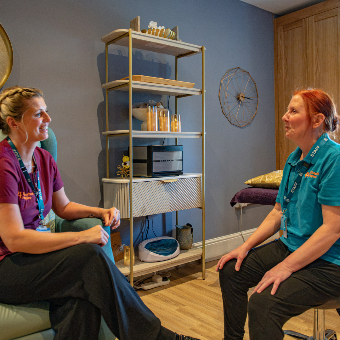 Two Rotherham Hospice staff members talking together in a calm wellbeing therapy room